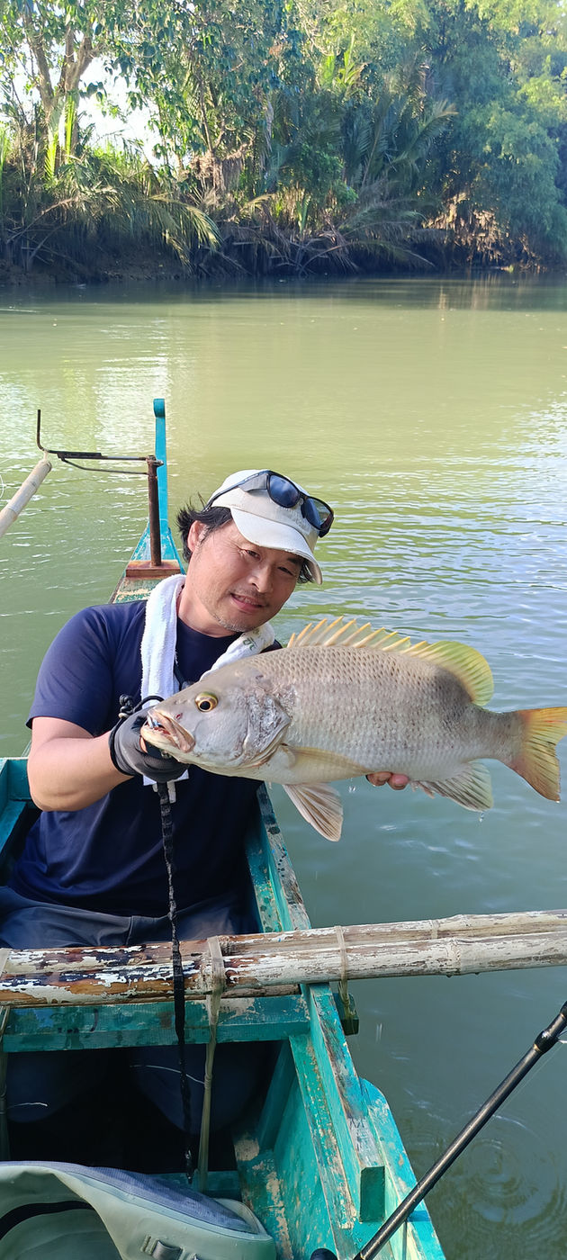 Customer posing with a snapper on the boat