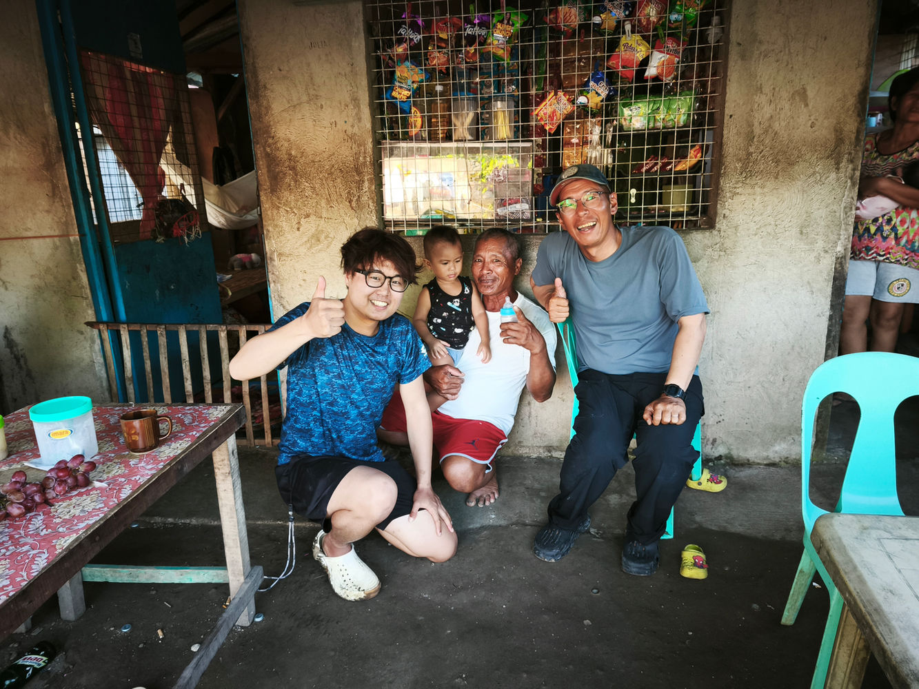 Group photo with the local community in front of a store