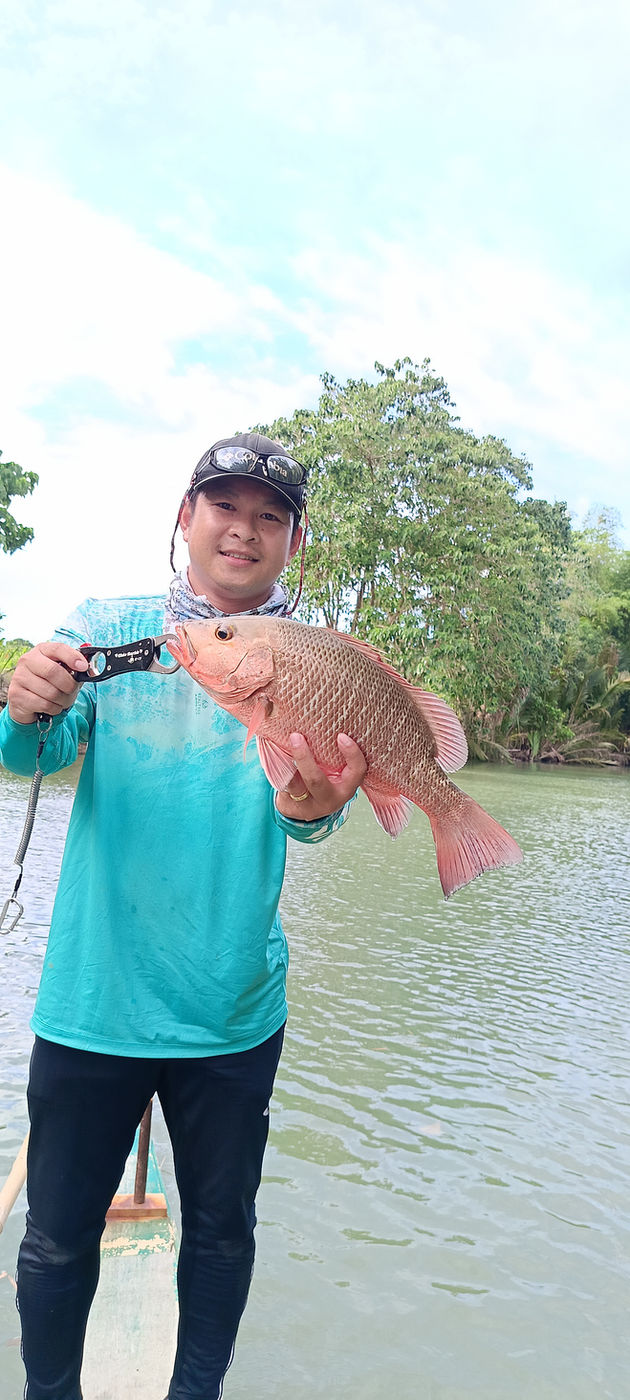 Angler with a mangrove jack on the boat